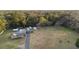 Expansive aerial view of a single-story home with a long driveway, detached garage, and lush green surroundings at 753 Glenwood Rd, Deland, FL 32720