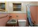 Retro bathroom featuring pink tile and a tub with shower at 753 Glenwood Rd, Deland, FL 32720