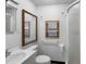 Modest bathroom featuring a vanity, toilet, window, and shower at 753 Glenwood Rd, Deland, FL 32720