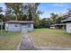 Exterior shot of a small, light blue house with a sidewalk and grassy yard at 753 Glenwood Rd, Deland, FL 32720