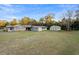 Exterior view of a residential property with a large yard and multiple outbuildings at 753 Glenwood Rd, Deland, FL 32720