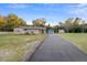 Charming single-story home with brick and siding exterior, featuring a long driveway and detached garage at 753 Glenwood Rd, Deland, FL 32720