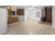 Open kitchen featuring tile flooring, wood cabinetry, and a breakfast bar, creating a cozy atmosphere at 753 Glenwood Rd, Deland, FL 32720