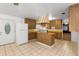 Bright kitchen with tile floors, wood cabinets, a center island, and a white refrigerator for a clean and classic look at 753 Glenwood Rd, Deland, FL 32720
