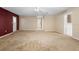 Large living room with neutral carpet, ceiling fan, and access to multiple rooms, creating an open feel at 753 Glenwood Rd, Deland, FL 32720