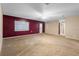Expansive living room with beige carpet, bright natural light, and neutral color palette at 753 Glenwood Rd, Deland, FL 32720