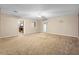 Spacious living room with neutral carpet, ceiling fan, and a glimpse into the adjacent kitchen area at 753 Glenwood Rd, Deland, FL 32720