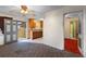 View of the living room connecting to the kitchen with a ceiling fan at 753 Glenwood Rd, Deland, FL 32720