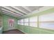 Enclosed sunroom with green wainscoting, lots of windows, and light-colored wood ceiling at 753 Glenwood Rd, Deland, FL 32720