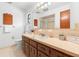 Well-lit bathroom with wood vanity, mirror, and peach colored countertop at 830 Freemans Farm Rd, Deland, FL 32720