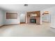 Spacious living room featuring a brick fireplace, arched doorways, and soft carpet at 830 Freemans Farm Rd, Deland, FL 32720