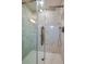 Modern walk-in shower featuring white marble-look tile, a glass door, and a rainfall shower head at 838 5Th St, Port Orange, FL 32129