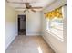 Light-filled dining room features tile floors, ceiling fan, and a window with yellow floral valance at 949 Wilmington Dr, Deltona, FL 32725