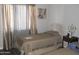 Bedroom with two twin beds features neutral walls, laminate floors, and natural light at 1101 Monticello Ln # 3, Port Orange, FL 32129