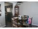 Cozy dining area features a wood table, seating for four, and dark laminate floors at 1101 Monticello Ln # 3, Port Orange, FL 32129