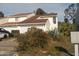 Two-story home with a large window and manicured bushes at 1101 Monticello Ln # 3, Port Orange, FL 32129