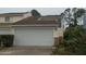 Attached garage with a white door on a two-story home at 1101 Monticello Ln # 3, Port Orange, FL 32129