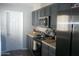 Galley kitchen features stainless steel appliances, gray cabinets, and laminate countertops at 1101 Monticello Ln # 3, Port Orange, FL 32129