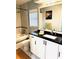 Updated bathroom features a shower/tub combo, updated vanity with dark countertops, and tiled floors at 112 Muscovy Ct, Daytona Beach, FL 32119