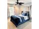 Cozy bedroom with carpeted floors, a modern ceiling fan, and a decorative mirror accent wall at 112 Muscovy Ct, Daytona Beach, FL 32119