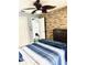 Bedroom features stone accent wall, ceiling fan, and carpeted floors at 112 Muscovy Ct, Daytona Beach, FL 32119