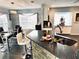 Modern kitchen with granite countertops, stone accents, stainless appliances, and an adjacent dining area at 112 Muscovy Ct, Daytona Beach, FL 32119