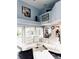 Open-concept living room with vaulted ceilings, hardwood floors, and large windows overlooking the pool at 112 Muscovy Ct, Daytona Beach, FL 32119