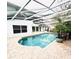Enjoy this private screened-in pool with brick pavers, lush landscaping, and a serene backyard at 112 Muscovy Ct, Daytona Beach, FL 32119