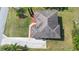 Aerial view of a house with a well-maintained roof, driveway, and landscaping at 12736 Lake Ridge Cir, Clermont, FL 34711