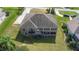 Aerial view of the property showing its layout, deck, screened in patio, and well-maintained landscaping at 12736 Lake Ridge Cir, Clermont, FL 34711