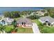 Aerial view of a beautiful home with a well-manicured lawn and stunning lake backdrop at 12736 Lake Ridge Cir, Clermont, FL 34711