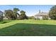 Expansive backyard with lush green lawn and mature trees creates a peaceful outdoor setting at 12736 Lake Ridge Cir, Clermont, FL 34711