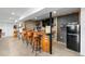 Basement wet bar featuring a barrel base, dark wall accent, and refrigerator at 12736 Lake Ridge Cir, Clermont, FL 34711