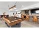 Basement game room featuring pool table and pub-style barrel bar, perfect for entertaining at 12736 Lake Ridge Cir, Clermont, FL 34711