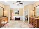 Bright bathroom features double vanities, decorative mirrors, tile flooring, and a separate shower area at 12736 Lake Ridge Cir, Clermont, FL 34711