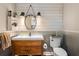Farmhouse-style bathroom featuring a wood vanity, rustic mirror, and shiplap walls at 12736 Lake Ridge Cir, Clermont, FL 34711