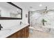 Elegant bathroom featuring double vanity, modern fixtures, and luxurious walk-in shower with decorative marble tiling at 12736 Lake Ridge Cir, Clermont, FL 34711