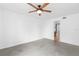 The interior of this bedroom features a ceiling fan and an adjacent bathroom at 12736 Lake Ridge Cir, Clermont, FL 34711