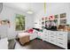 Bright bedroom with vinyl record decor on the wall and a large window providing natural light at 12736 Lake Ridge Cir, Clermont, FL 34711