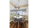 Cozy dining area featuring a round table with chairs, a stylish chandelier, and wood floors at 12736 Lake Ridge Cir, Clermont, FL 34711