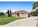 Beautiful single-story home featuring a spacious driveway and lush landscaping at 12736 Lake Ridge Cir, Clermont, FL 34711
