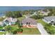 Lovely exterior of home featuring beautiful landscaping, mature trees, and peaceful lake views at 12736 Lake Ridge Cir, Clermont, FL 34711