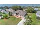Stunning home with meticulously landscaped yard, mature palms, and water view at 12736 Lake Ridge Cir, Clermont, FL 34711
