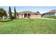 Well-maintained front lawn featuring a charming single-story home with a beautiful fountain at 12736 Lake Ridge Cir, Clermont, FL 34711