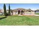 Charming single-story home with a well-manicured lawn, complemented by an elegant fountain and garden at 12736 Lake Ridge Cir, Clermont, FL 34711