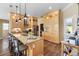 Bright kitchen boasts wooden cabinets, granite countertops, stainless steel appliances, and an island with barstool seating at 12736 Lake Ridge Cir, Clermont, FL 34711