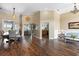 Open-concept living room with hardwood floors, seamlessly connecting to the dining area and kitchen at 12736 Lake Ridge Cir, Clermont, FL 34711