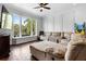 Comfortable living room with a sectional couch, large windows, and stylish decor at 12736 Lake Ridge Cir, Clermont, FL 34711