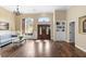 Spacious living room featuring hardwood floors, a large window, and elegant furnishings at 12736 Lake Ridge Cir, Clermont, FL 34711