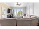 Cozy living room with large windows offering scenic views and a comfortable sectional couch at 12736 Lake Ridge Cir, Clermont, FL 34711